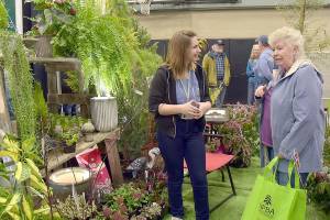 Dianne McIntosh of Sequim, right, chats about gardening with Jayde Carean, an employee of New Dungeness Nursery, during Saturday's Building, Remodeling & Energy Expo at Sequim Middle School. The two-day event, hosted by the North Peninsula Building Association and sponsored by Clallam County PUD No. 1., featured displays, workshops and vendor booths showcasing a variety of building products and services. (Keith Thorpe/Peninsula Daily News)