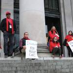 Photo by Mary Murphy/Washington State Journal / Protestors gather at the top of the Capitols North steps, among them Vancouver residents Jeremy Hopkins of SeaMar Community Health Services and Duana Johnson from Washington Low Income Housing Alliance.