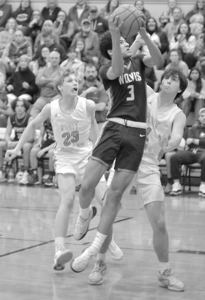 Photo by Keith Thorpe/Olympic Peninsula News Group
Sequims Solomon Shepard, center, takes his shot surrounded by Port Angeles William Ruddell, left, and Blake Sohlberg at Port Angeles High School on Feb. 6.