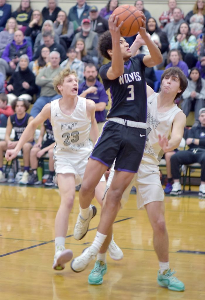 Photo by Keith Thorpe/Olympic Peninsula News Group
Sequims Solomon Shepard, center, takes his shot surrounded by Port Angeles William Ruddell, left, and Blake Sohlberg at Port Angeles High School on Feb. 6.