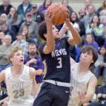 Photo by Keith Thorpe/Olympic Peninsula News Group
Sequims Solomon Shepard, center, takes his shot surrounded by Port Angeles William Ruddell, left, and Blake Sohlberg at Port Angeles High School on Feb. 6.