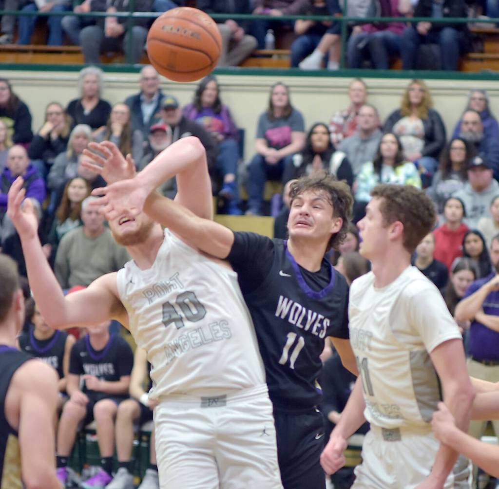 Photo by Keith Thorpe/Olympic Peninsula News Group
Sequims Charlie Grider, center, fights for a rebound with Port Angeles Isaiah Shamp, left, as Port Angeles Dallas Dunning looks on during the teams Olympic League finale in Port Angeles on Feb. 6.