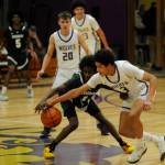 Sequim Gazette photo by Michael Dashiell / Sequims Solomon Sheppard, right, steals the ball from Evergreens Leebaan Sami in the first half of the Wolves 73-61 bi-district tournament win on Feb. 13. Looking on is Sequims Mason Rapelje (20) and Charlie Grider.