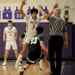 Sequim Gazette photo by Michael Dashiell
Sequims Solomon Sheppard, center, defends Evergreens Miguel Delgado in the first half of the Wolves 73-61 bi-district tournament win on Feb. 13. Looking on is Sequims Keenan Green.