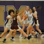 Sequim Gazette photo by Michael Dashiell / Sequims Bobbi Mixon, left, guards Sydney VanHoof as SHS teammate Raimey Brewer looks on in a bi-district tournament game on Feb. 14 in Sequim.