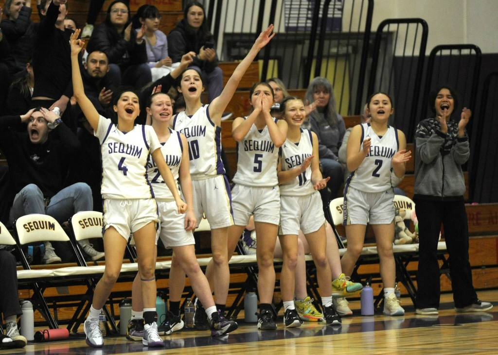 Sequim Gazette photo by Michael Dashiell / Sequims bench erupts in cheers after the Wolves capitalized on a North Mason turnover in a bi-district tournament match-up on Feb. 16. Pictured are, from left, Gracie Chartraw, Rilynn Whitehead, Clare Turella, Raimey Brewer, Kiley Winter and Sydney Thomas-Harris.