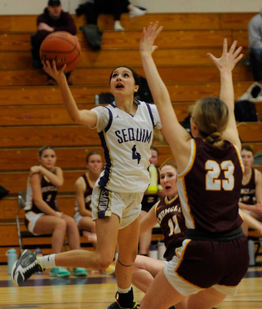 Sequim freshman guard Gracie Chartraw drives past Enumclaws Ava Smith in a bi-district tournament game on Feb. 14 in Sequim. Chartraw led the Wolves with 27 points.