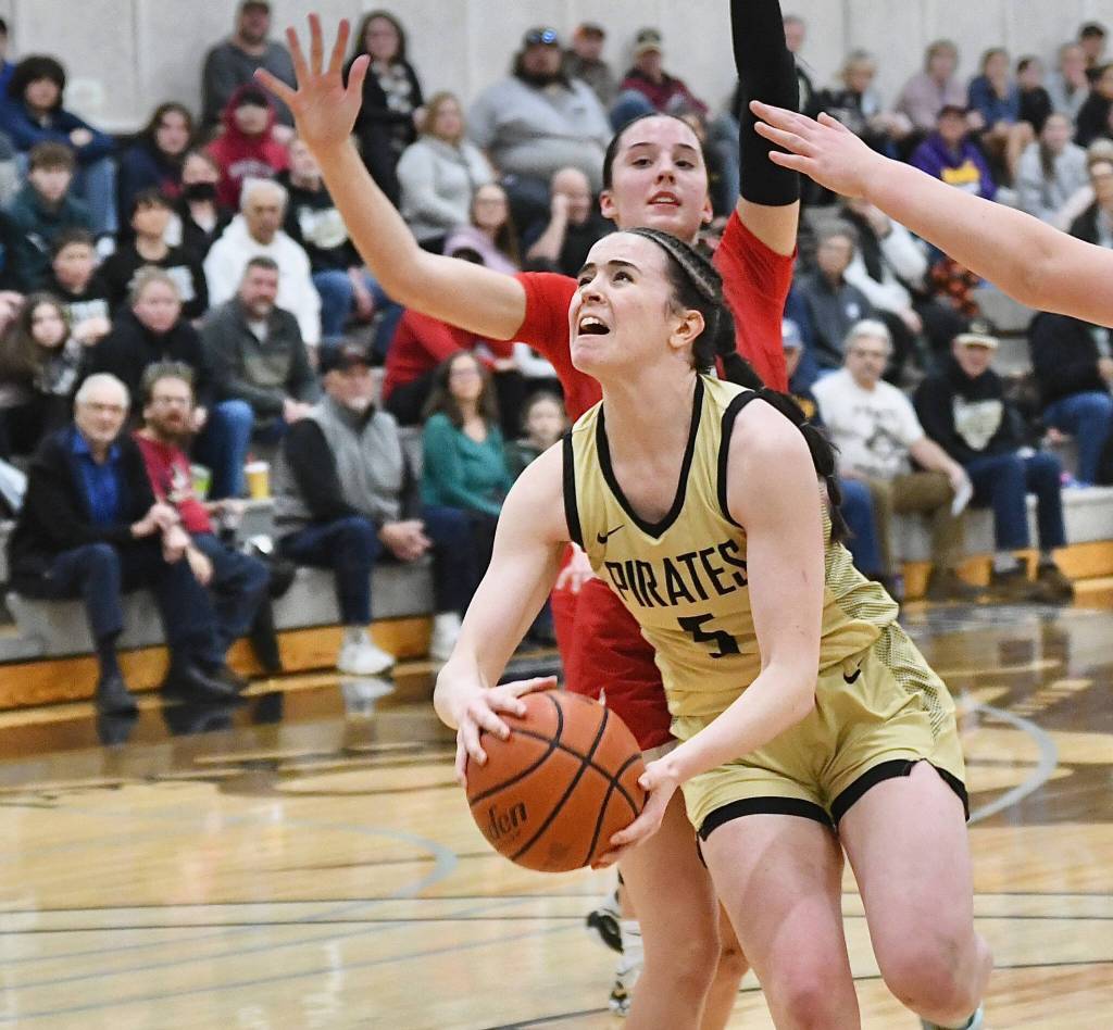 Photo by Jay Cline/Peninsula College / Peninsulas Alexa Mackey drives to the basket as the Pirates take on (and beat) Skagit Valley on Feb. 21 at home. Alexa Mackey had five points and eight rebounds in the win.