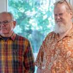 Photo by Emily Matthiessen / Tom McCurdy and Erik Evans, Parking Lot Pipers, watch as their protege Heidi Slack demonstrates the small pipes.