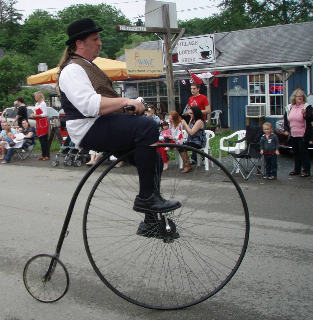 Checking out the old way of cycling during a Canada Day Parade in Sherbrooke, Nova Scotia.