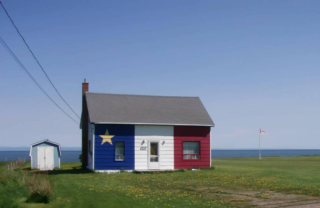 Photo courtesy of Tony and Jen Burgess / House painted in colors of Acadian flag in Grand-Anse, New Brunswick.