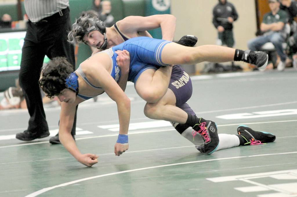 File photo by Keith Thorpe/Olympic Peninsula News Group / Sequims Jayms Vilona, top, pictured bringing down Olympics Gabriel Eriz in the 144-pound weight class at the Battle of the Axe in Port Angeles in January, was named to the all-Olympic League second team.