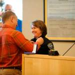 Sequim Gazette file photo by Matthew Nash/ Pat Crain pins on the police chief badge on his wife after shes sworn in on Dec. 16, 2016.