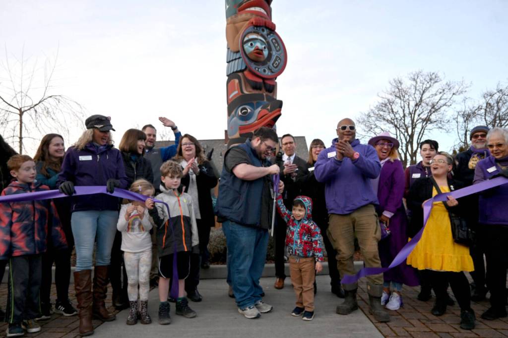 Sequim Gazette photo by Michael Dashiell / Sequim mayor Brandon Janisse cuts the ceremonial ribbon to open the Sequim Sunshine Festival at the Sequim Civic Center Plaza on March 1.