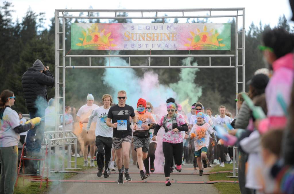 Sequim Gazette photo by Michael Dashiell / Runners and walkers break from the starting line at the Sequim Sunshine Festivals Sun Fun Color Run at Carrie Blake Community Park on March 2.