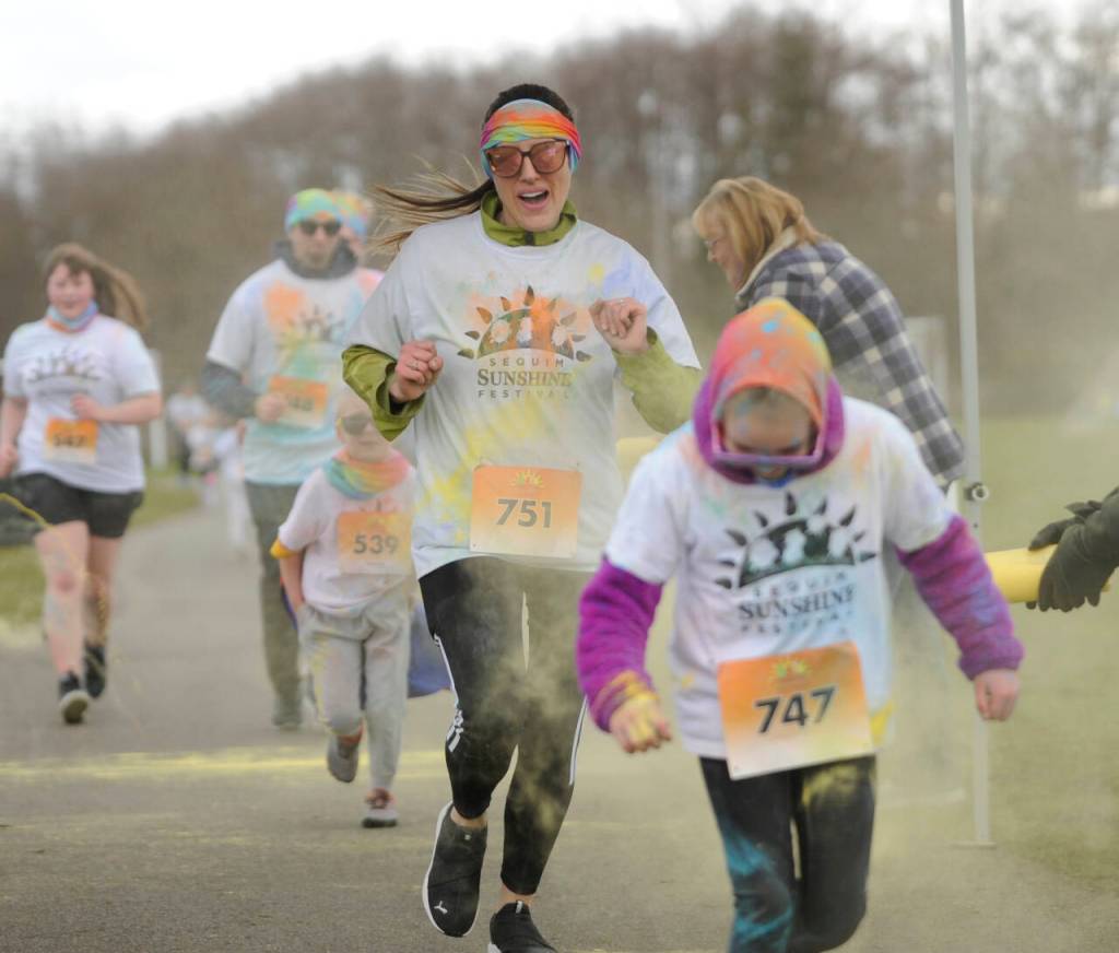 Sequim Gazette photo by Michael Dashiell / Jennay Kirschner (No. 751) of Vaughn, Wa., and others enjoy the 1k Sun Fun Color Run at Carrie Blake Community Park on March 2.