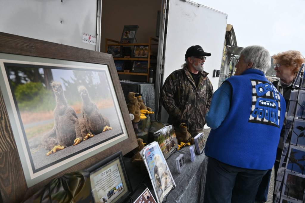 Sequim Gazette photo by Michael Dashiell / Sequim photographer Keith Ross talks with attendees of the Sequim Sunshine Festival on March 2.