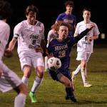 Sequim Gazette photo by Matthew Nash / Sequims Max Stanford, center, vies for the ball with Port Angeles Jacob Weaver in SHSs season-opening 4-2 win on March 14.