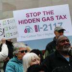 Photo by Aspen Anderson/Washington State Journal / Protestors and signature gatherers on the citizen initiatives gather on the capitol steps, with some holding signs to Stop the hidden gas tax.