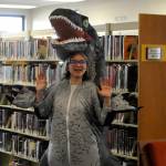 Sequim Gazette photo by Matthew Nash/ Abigail West, 14, dresses as a T-Rex for the librarys send-off celebration before its renovated and expanded over the next year. Itll reopen at a temporary space in the former Brians Sporting Goods on April 1. West said she comes to the library for Teen Night and her costume was following her moms motif that its free to have a good time.
