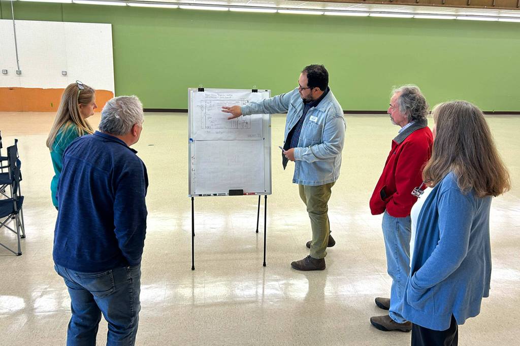 Sequim Gazette photos by Matthew Nash
Noah Glaude, NOLS executive director, shows library trustees the floor plan of the temporary Sequim Library at 609 W. Washington St. on March 9. It will open on April 1 after all the current librarys materials and equipment are moved for construction.