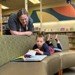 Sequim Gazette photo by Matthew Nash
Rachel Tax talks to her four-year-old son AJ while he reads a book in the childrens section of the Sequim Library on March 9. She said they visited one last time before it closes temporarily for construction so that her daughter Anna-Marie could check out some cat books for a 4-H report.