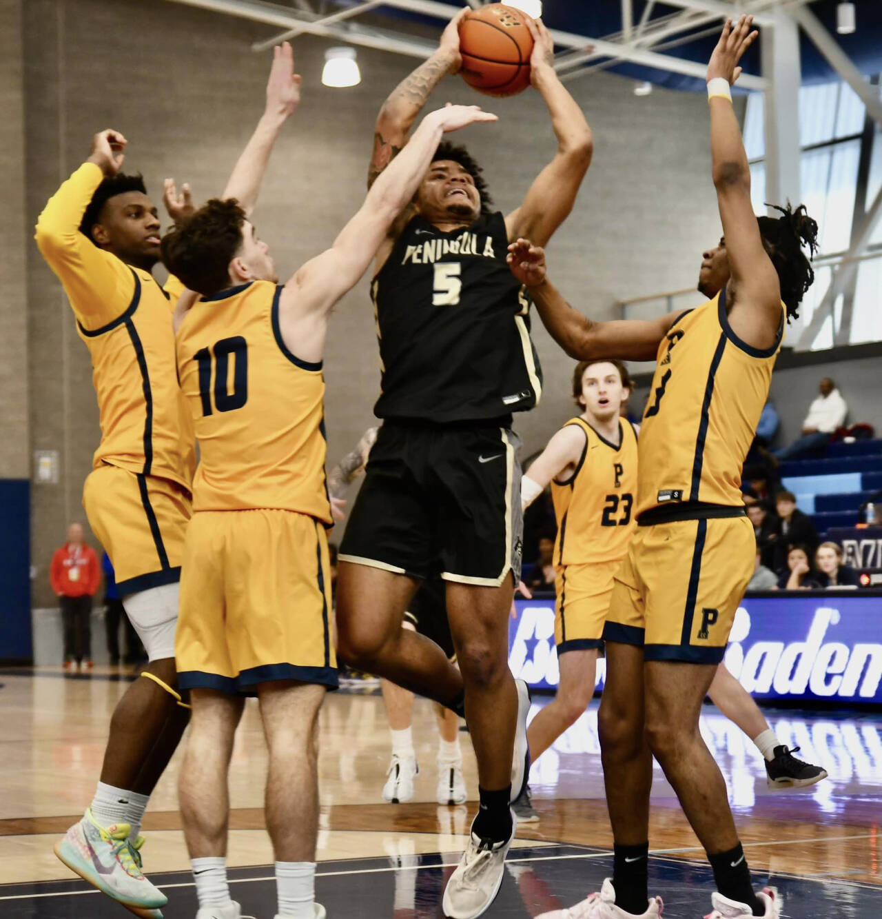 Photo by Jay Cline/Peninsula College / Peninsula Colleges Javon Ervin (5) slices through the Portland defense in search of a score in the opening round of the NWAC tournament in Pasco on March 6.