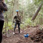 Sequim Gazette file photo by Matthew Nash / Powell Jones, executive director of the Dungeness River Audubon Center, shows students how to use tools like a McLeod for clearing trail in 2017.