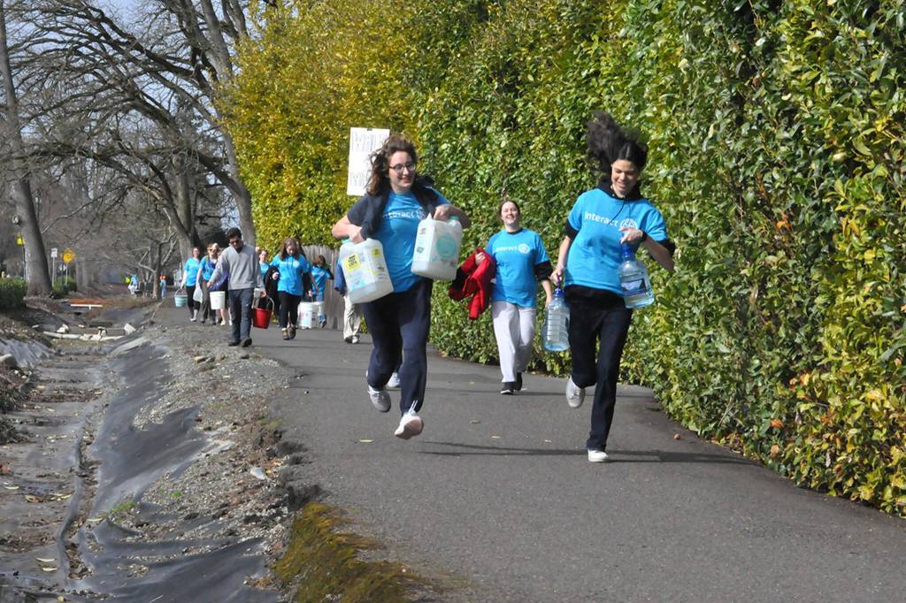 Sequim Gazette photo by Matthew Nash
Sequim High Schools Interact Club members along with a few Sequim Sunrise Rotary members walk along the Olympic Discovery Trail on March 9 for their annual Walk for Water event. They carry water from the Dungeness River to Sequim Middle School to symbolize the journey people take daily for clean water.