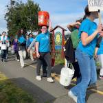 Sequim Gazette photo by Matthew Nash
Sequim High Schools Interact Club members along with a few Sequim Sunrise Rotary members walk along the Olympic Discovery Trail on March 9 for their annual Walk for Water event. They carry water from the Dungeness River to Sequim Middle School to symbolize the journey people take daily for clean water.