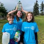 Sequim Gazette photo by Matthew Nash/ Interact Club members, from left, Zee French, London Forrest, and Kaitlyn Carpenter carry containers during the Walk for Water event on March 9 from the Dungeness River to Sequim Middle School. Students carry water as part of a fundraiser to build a well for a school in Africa.