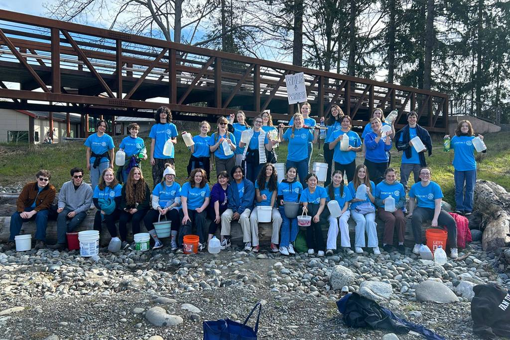 Sequim Gazette photo by Matthew Nash/ Students gather by the Dungeness River Railroad Bridge before walking two miles with containers filled with water on March 9 to symbolize the struggle people face everyday walking for clean water.