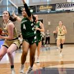 Peninsula College's Alexa Mackey goes to the rim up against Umpqua's Amaya Afatasi (4) on Saturday in Pasco. Trailing the play are Peninsula's Jenilee Donovan (11) and Shania Moananu (24). Umpqua won 73-55.(Jay Cline/Peninsula College)