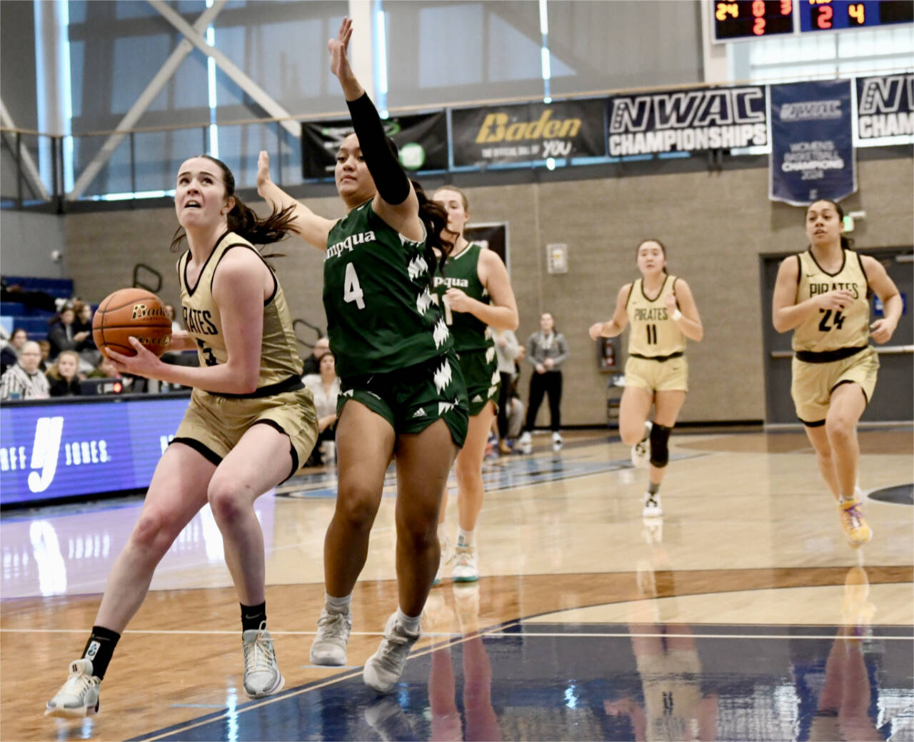 Photo by Jay Cline/Peninsula College / Peninsula Colleges Alexa Mackey goes to the rim up against Umpquas Amaya Afatasi (4) on March 2 in Pasco. Trailing the play are Peninsulas Jenilee Donovan (11) and Shania Moananu (24). Umpqua won 73-55.