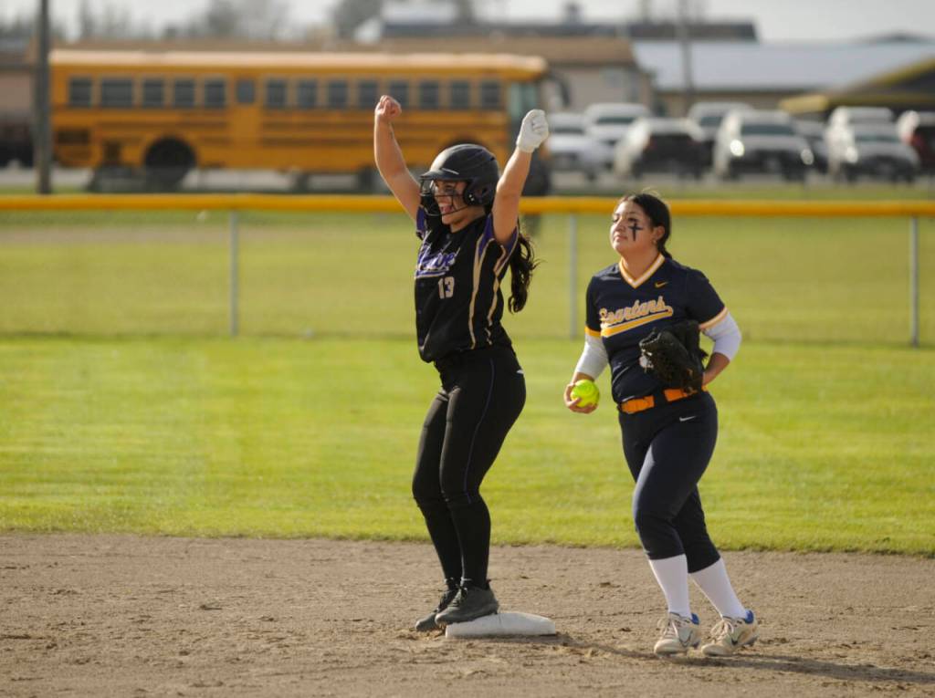 Sequim Gazette photo by Michael Dashiell / Sequims Taylee Rome, left, celebrates a run-scoring double in the first inning of the Wolves 7-3 win over Forks on March 12. Looking on is Forks Lizzy Soto.