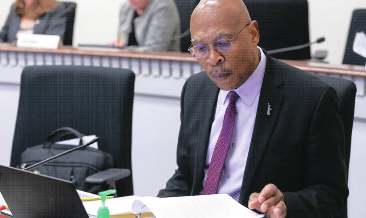 Photo courtesy of Senate Democrats / Sen. John Lovick studies a proposal at his desk on the floor of the Senate.