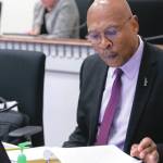 Photo courtesy of Senate Democrats / Sen. John Lovick studies a proposal at his desk on the floor of the Senate.