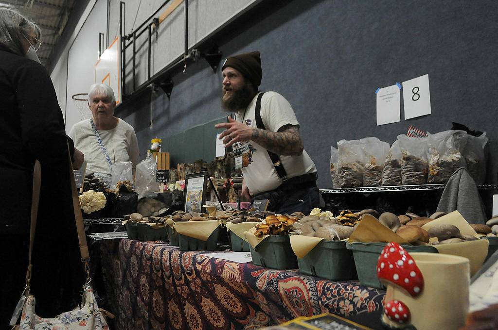 Sequim Gazette photo by Matthew Nash/ David Rogers with Maddies Mushrooms from the Joyce area speaks to visitors of the Soroptimist Gala Garden Show on March 16 inside the Sequim Boys & Girls Club. He said it was his first time at the show and was having a great time and response.