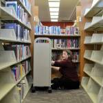Sequim Gazette photo by Matthew Nash/ Corrina Desmarais, older adult services librarian, fills a cart inside the Sequim Library last weekend as she and other staff prepare to move and open a temporary library across the city on April 1.