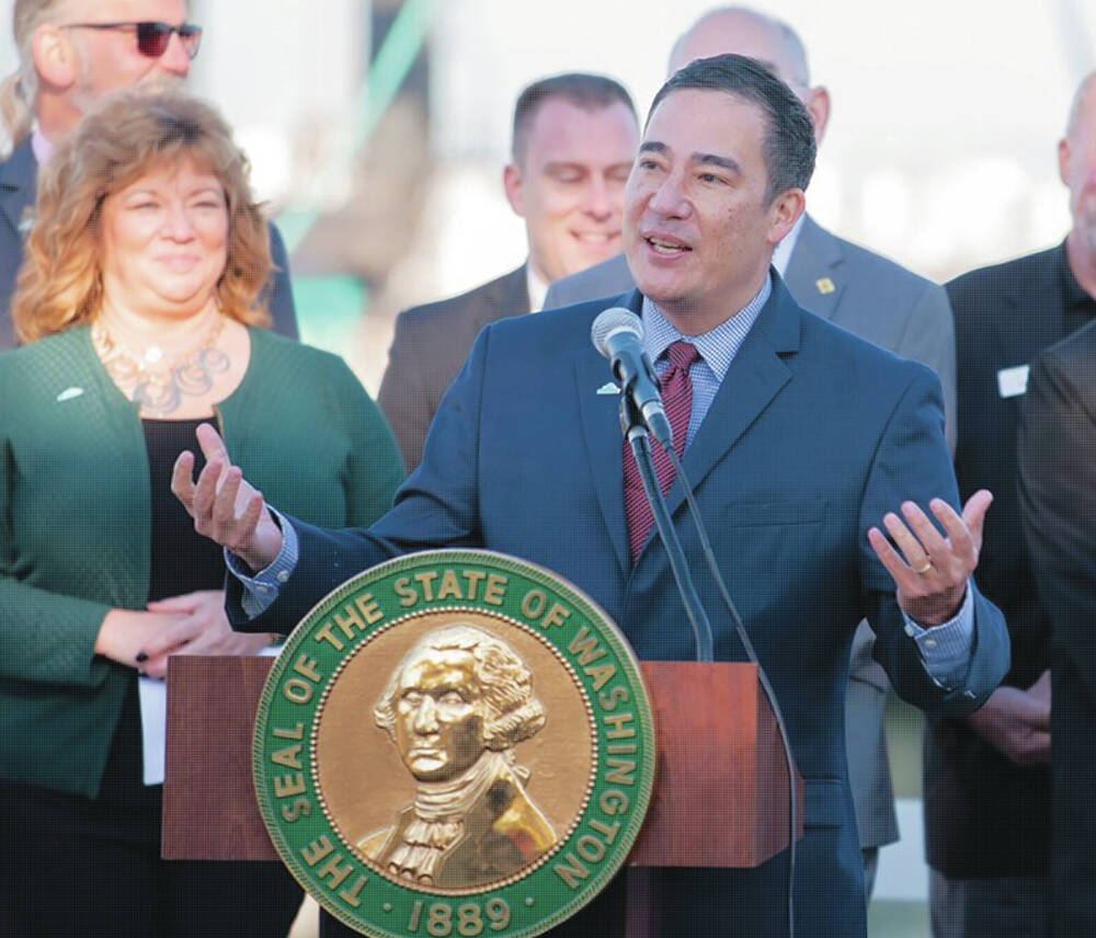 Photo courtesy of Secretary of States office / Secretary of State Steve Hobbs, who backed legislation to require additional security systems for county elections, speaks before an audience.