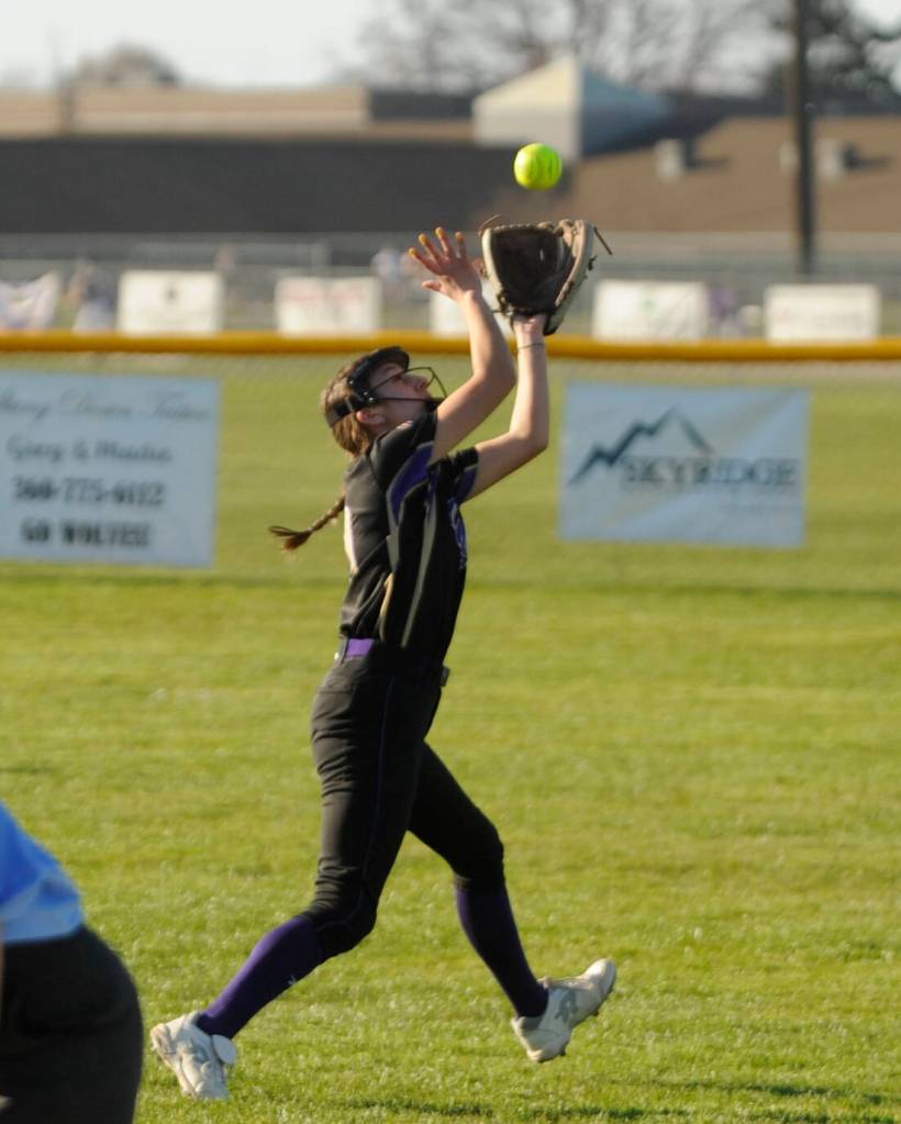 Sequim Gazette photo by Michael Dashiell / Sequim second baseman Mia Kirner makes an over-the-shoulder catch of a pop fly as the Wolves take on Bainbridge on March 19.