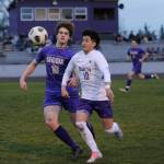 Sequim Gazette photo by Michael Dashiell / Sequims Sam Stewart, left, battles North Kitsaps Pepe Deluna for possession in the Wolves 4-0 home loss to NKs Vikings on March 21.