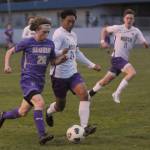 Sequim Gazette photo by Michael Dashiell / Sequims Max Stanford, left, races into North Kitsap territory and is challenged by Viking Ayden Jueco in a March 21 Olympic League match-up in Sequim.