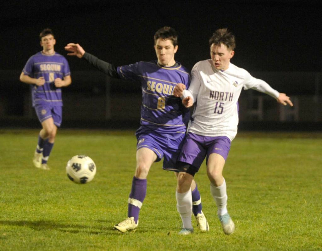 Sequim Gazette photo by Michael Dashiell / Sequims Kyhlan Henderson, left, and North Kitsaps Logan Anderson vie for the ball in the second half of a March 21 league match-up in Sequim.