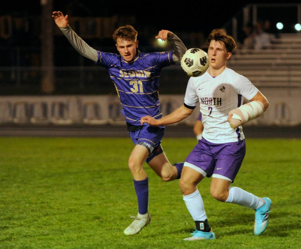 Sequim Gazette photo by Michael Dashiell / Sequims Mason Rapelje, left, pressures North Kitsaps Mason Chmielewski in the second half of an Olympic League match-up on March 21. North Kitsap won, 4-0.