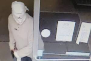 Surveillance video footage shows a man brandishing a gun at the Dollar Tree store in Port Angeles. (Clallam County Sheriff's Office)