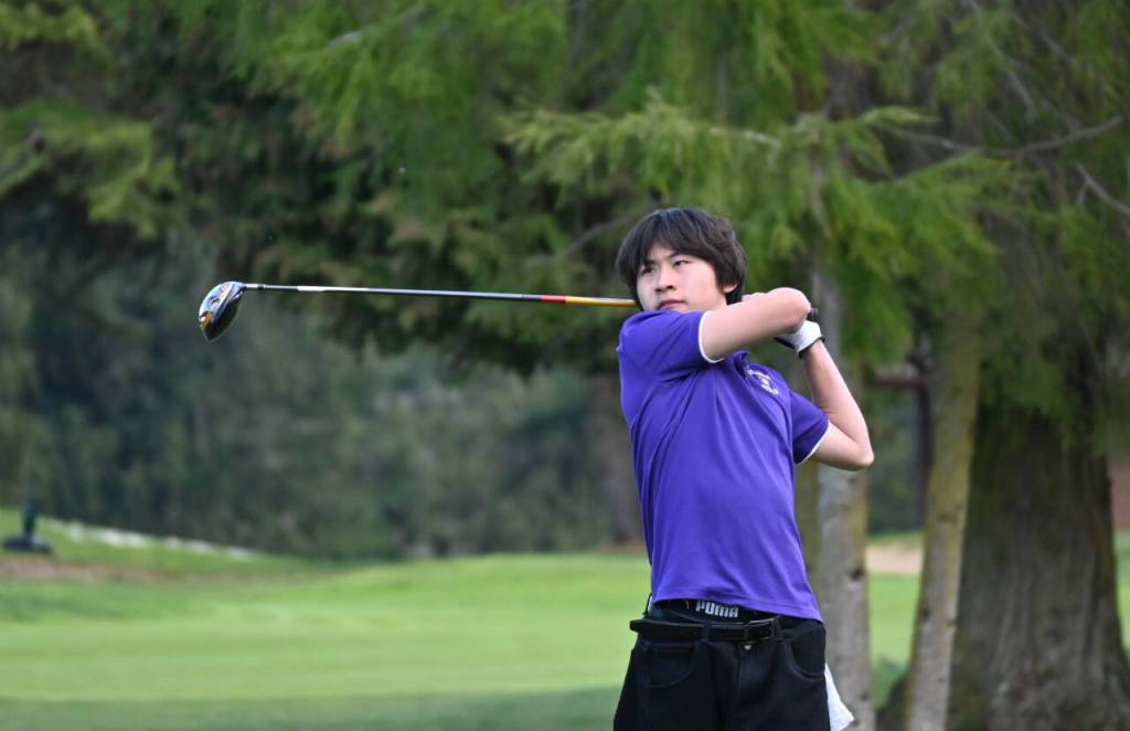 Sequim Gazette photo by Michael Dashiell / Sequims Joey Kang tees off as he and the Wolves take on Bainbridge at home on March 21.