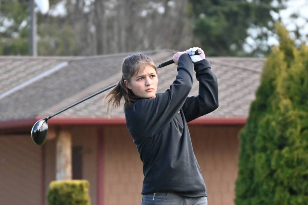 Sequim Gazette photo by Michael Dashiell / Sequims Raimey Brewer tees off at hole No. 1 at The Cedars at Dungeness on March 21 in a matcha against Bainbridge.