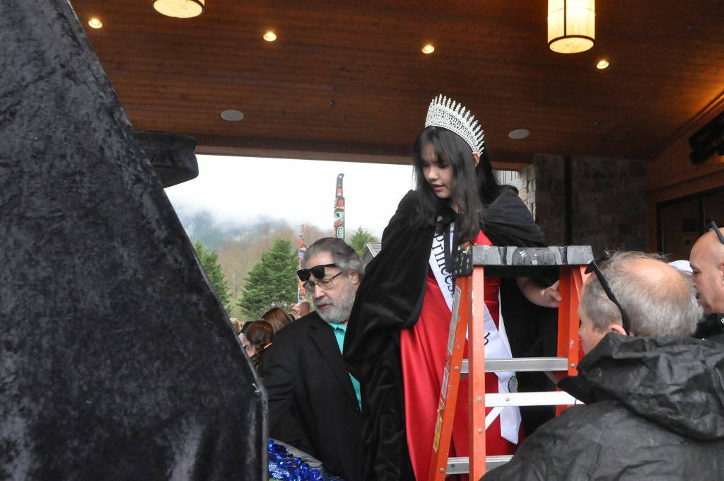 Sequim Gazette photo by Matthew Nash/ Princess Kailah Blake climbs onto the royalty float for the first time on March 23. She and fellow Irrigation Festival royalty will go to 14 parades this year.