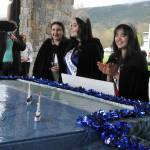 Sequim Gazette photo by Matthew Nash/ Princess Ashlynn Northaven, Queen Ariya Goettling, Princess Kailah Blake, and Princess Sophia Treece take a closer look at their float for the 2024 season.